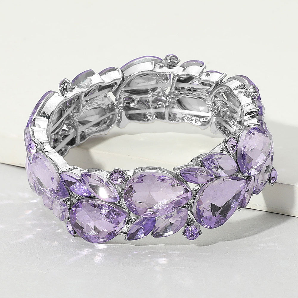 Jewelry bracelet with purple and clear gemstones on a white background