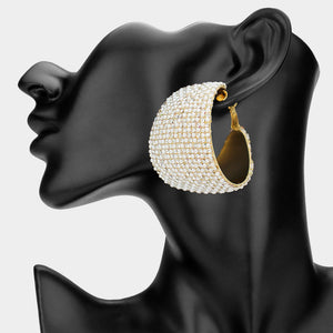 White bling pavé crystal wide hoop earrings on gold-tone metal with dense faceted rhinestone coverage and omega backs, displayed on a black mannequin profile.