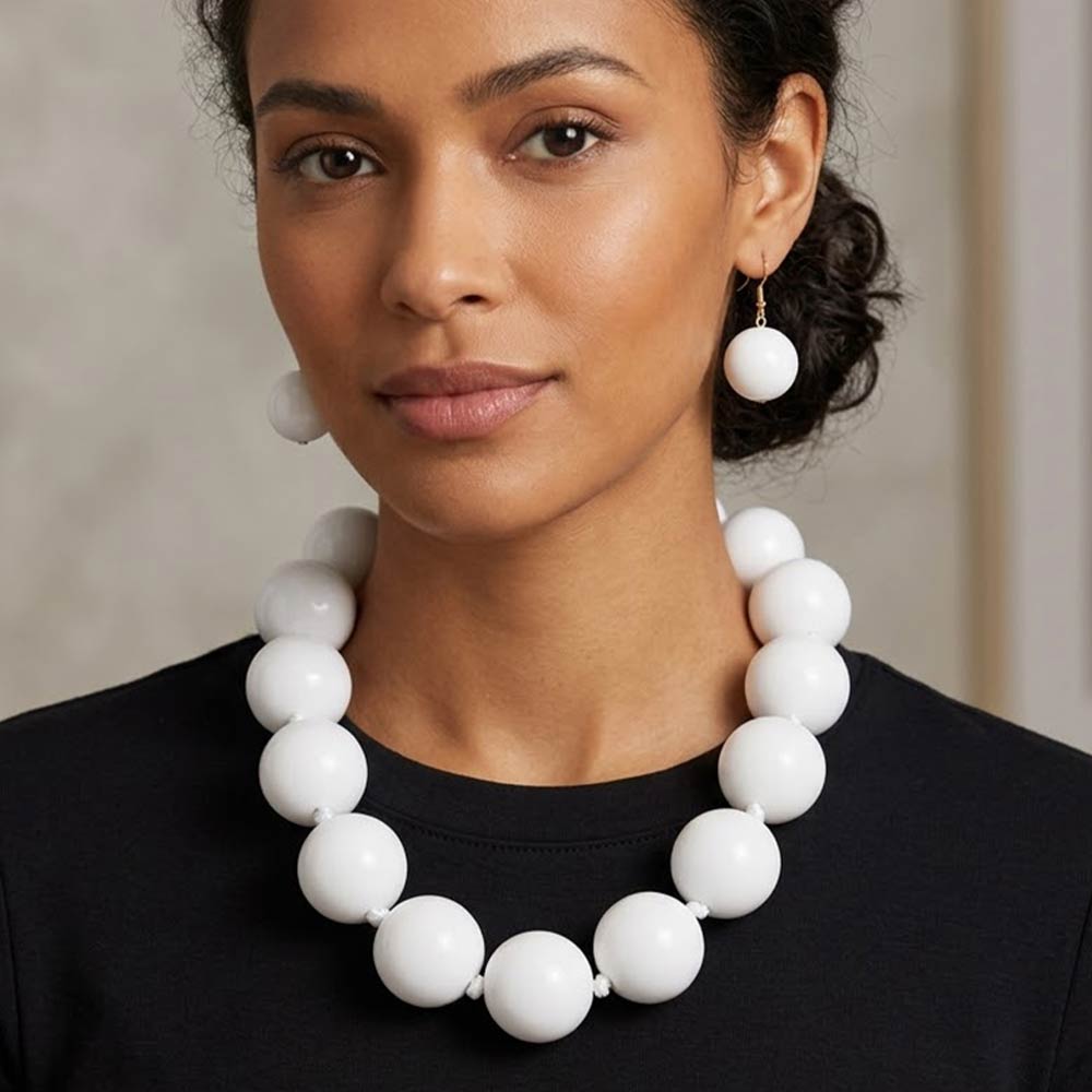 Model wearing White chunky ball beaded statement necklace set with oversized round beads, matching drop earrings.
