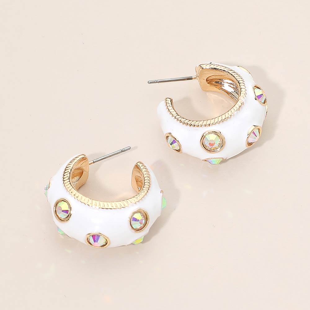 White enamel huggie hoop earrings with AB stones 1 inch size shown on a beige background