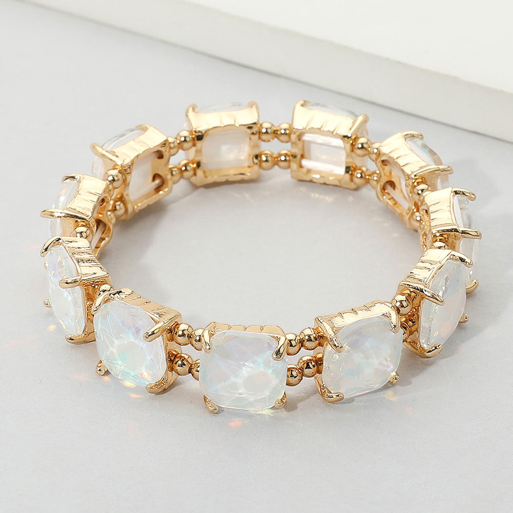 White opal cushion square stone stretch evening bracelet on gold, elegant statement bracelet for bridal and evening wear on a white background