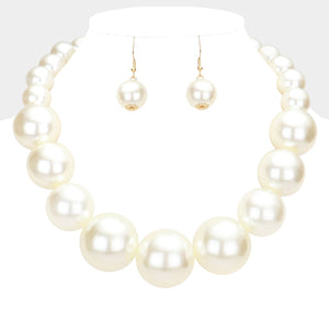 White Oversized Graduated Pearl Glossy Statement Necklace Set on silver on a white background.