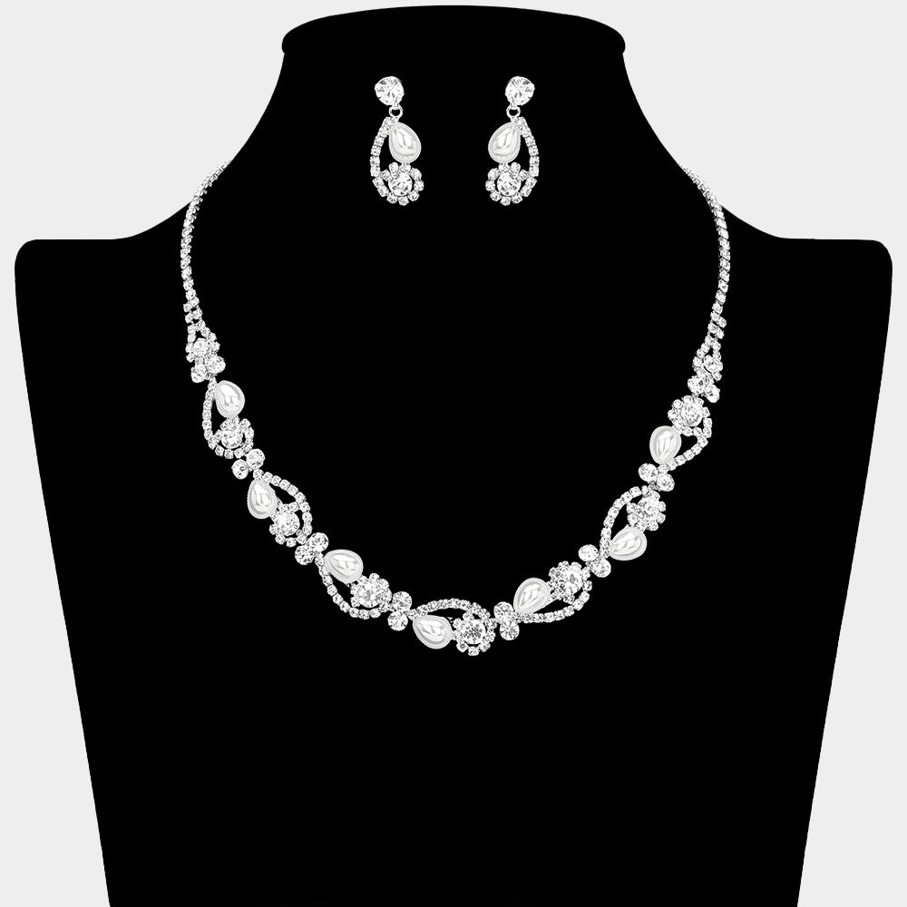 White pearl and clear crystal bridal necklace set on silver with alternating pearl and crystal accents and matching drop earrings, displayed on a black jewelry bust.