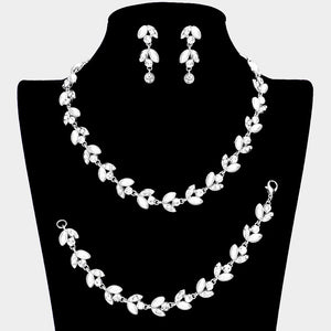 White pearl and crystal bridal jewelry set in a silver finish featuring a coordinating necklace, drop earrings, and bracelet with leaf-inspired accents, displayed on a black jewelry bust with a model wearing the set.