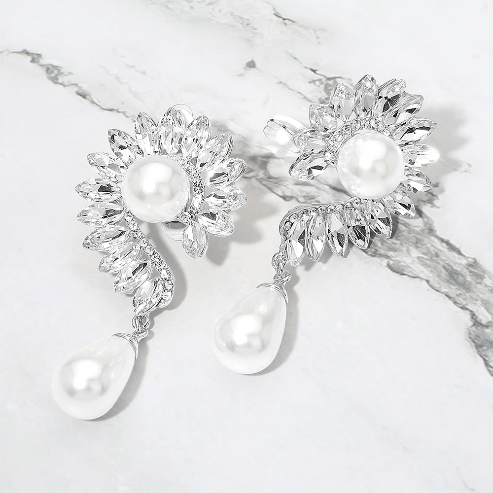 White pearl and marquise crystal cluster clip-on earrings on silver on a white marble background