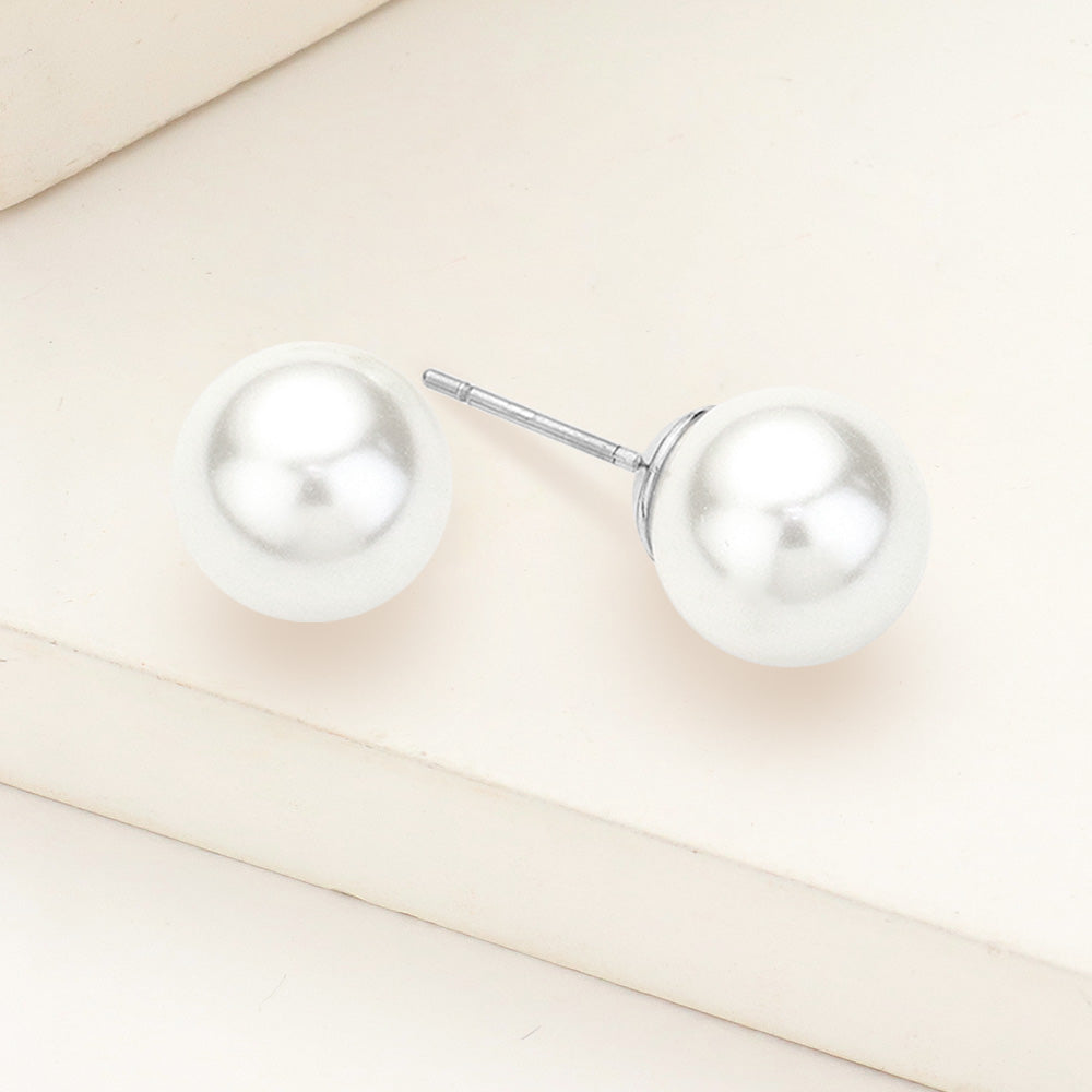 White pearl stud earrings 0.4 inch 10mm on silver on beige background
