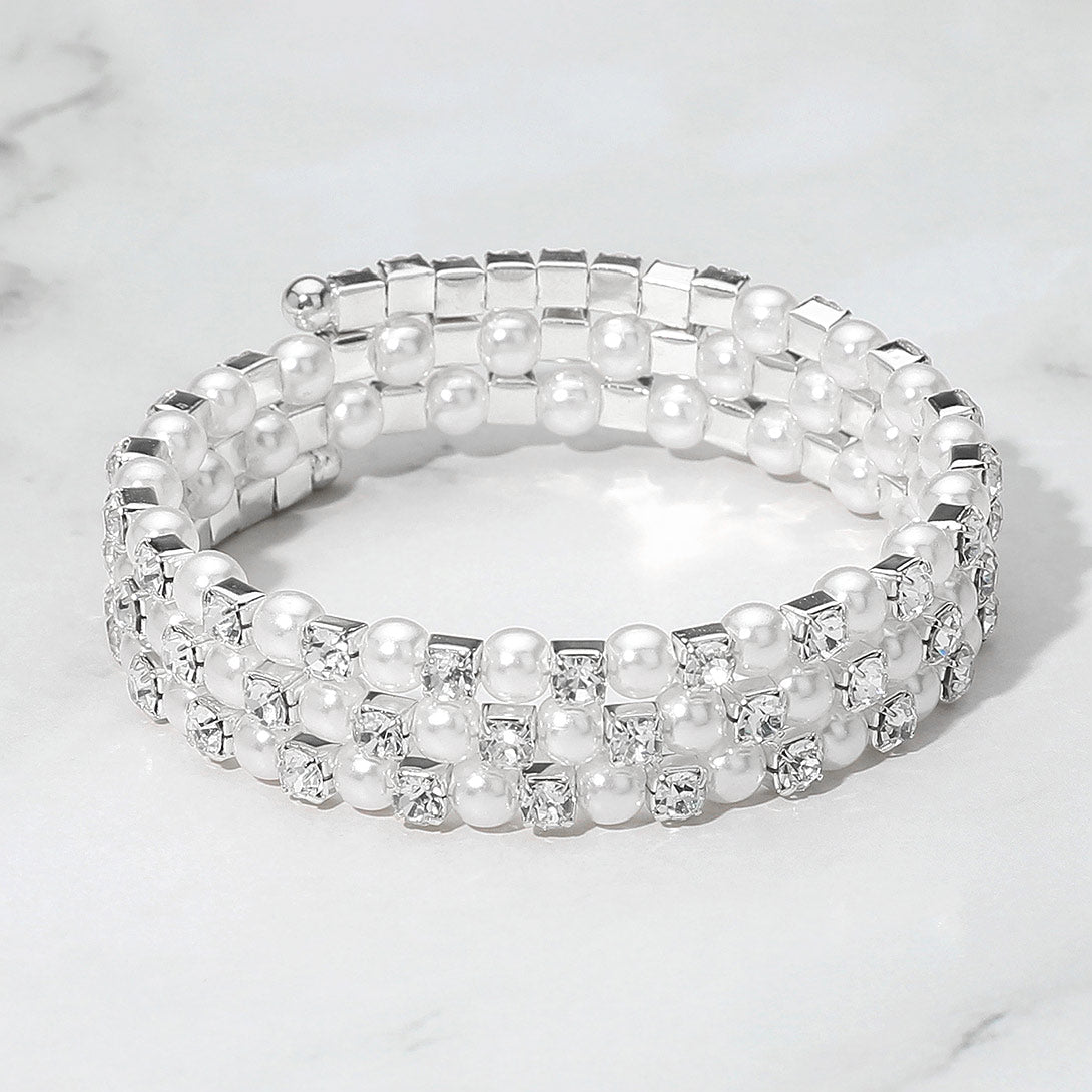 White Pearl and Rhinestone Lined Ajustable Coil Like Bracelet on a gray background