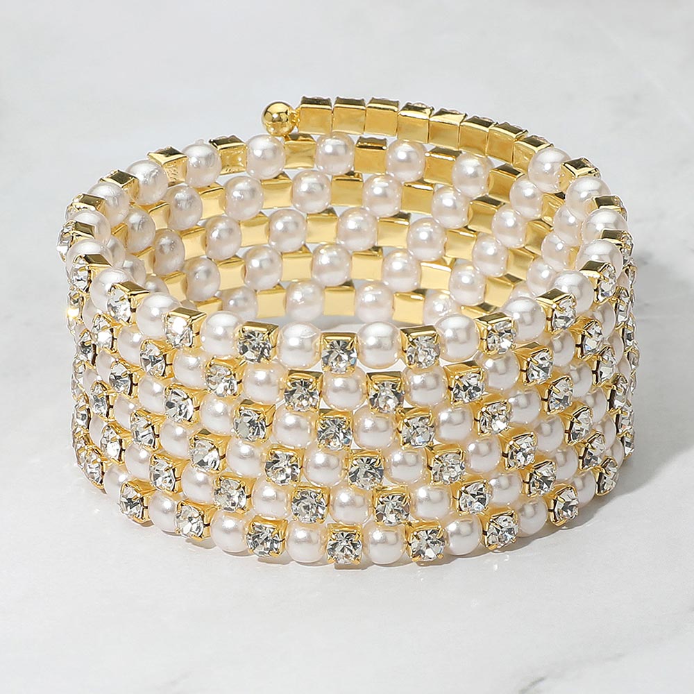 Wide Cream Pearl and Rhinestone Lined Ajustable Coil Like Bracelet on a gray background