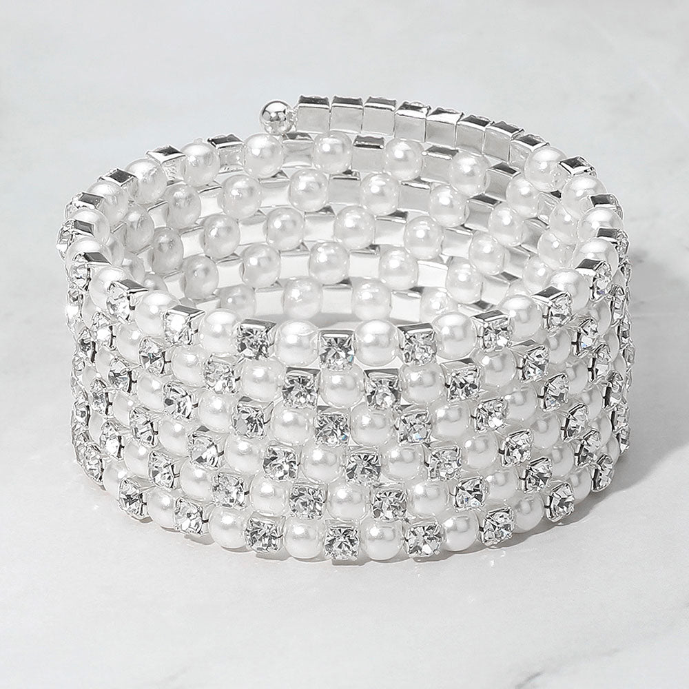 Wide White Pearl and Rhinestone Lined Ajustable Coil Like Bracelet on a gray background