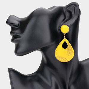 Yellow resin teardrop cutout dangle earrings on a black mannequin ear on a white background— bold modern 3.25" fashion statement jewelry.