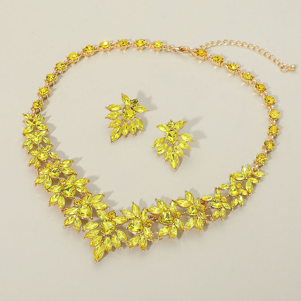 Yellow marquise floral statement necklace set on gold on a beige background