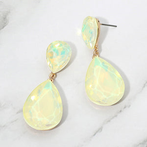 Yellow opal crystal double teardrop dangle earrings on gold displayed on a white marble background.