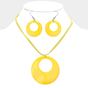 Yellow open-circle necklace set on silver with an oversized round pendant and matching open-circle earrings, displayed on a white jewelry bust.