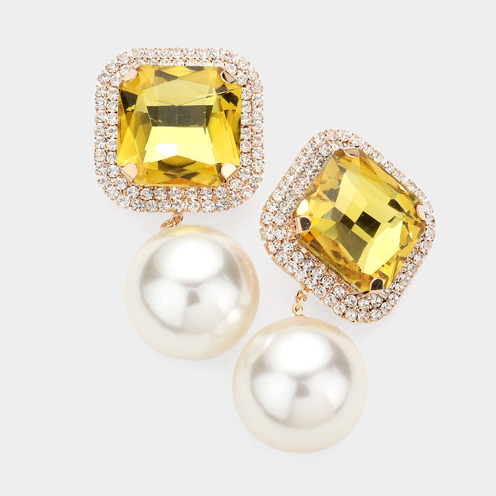 Yellow square stone pearl drop clip-on earrings with gold-tone setting and structured dangle design on a light gray background
