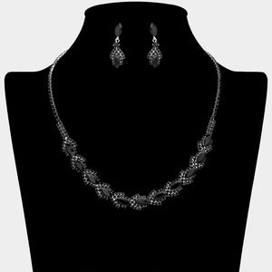 Black marquise crystal necklace set on silver-tone settings, with a slim line of small crystals leading to leaf-shaped marquise stones edged in tiny crystals and matching drop earrings. The necklace measures 16 inches plus a 4-inch extender, with 0.4-inch decor; earrings are 0.9 inches long. Displayed on a black necklace bust against a light gray background.