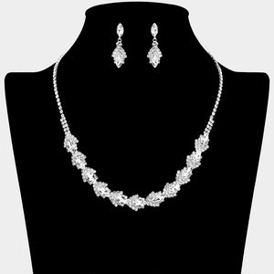 Clear crystal marquise necklace set on silver-tone settings, with a slim line of small crystals leading to leaf-shaped marquise stones edged in tiny crystals and matching drop earrings. The necklace measures 16 inches plus a 4-inch extender, with 0.4-inch decor; earrings are 0.9 inches long. Displayed on a black necklace bust against a light gray background.
