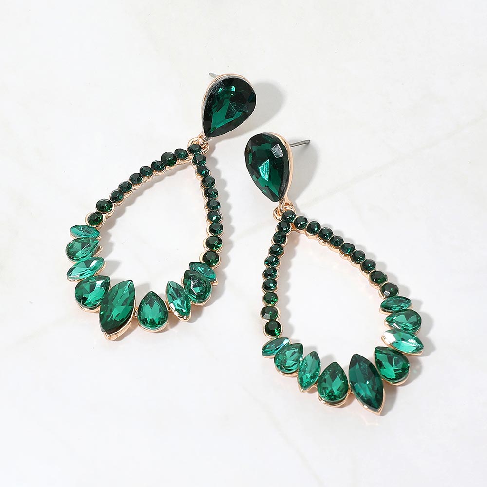 Emerald green crystal open teardrop dangle earrings on gold-tone settings, measuring 1.25 inches wide by 2.6 inches long. Faceted teardrop tops connect to open drops edged with small round crystals and larger teardrop and marquise-shaped stones along the bottom, displayed on white marble.