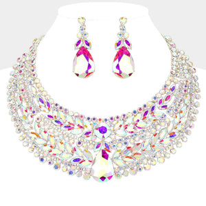 AB iridescent crystal statement necklace set on silver-tone metal, featuring a broad, layered bib of marquise and round stones with a large teardrop centerpiece and matching teardrop earrings reflecting rainbow colors. Necklace measures 17 inches plus a 2-inch extender, with 2.25-inch decor; earrings are 2.2 inches long. Displayed on a white jewelry bust against a light gray background.