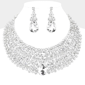 Clear crystal statement necklace set on silver-tone metal, featuring a broad, layered bib of marquise and round stones with a large teardrop centerpiece and matching teardrop earrings. Necklace measures 17 inches plus a 2-inch extender, with 2.25-inch decor; earrings are 2.2 inches long. Displayed on a white jewelry bust against a white background.