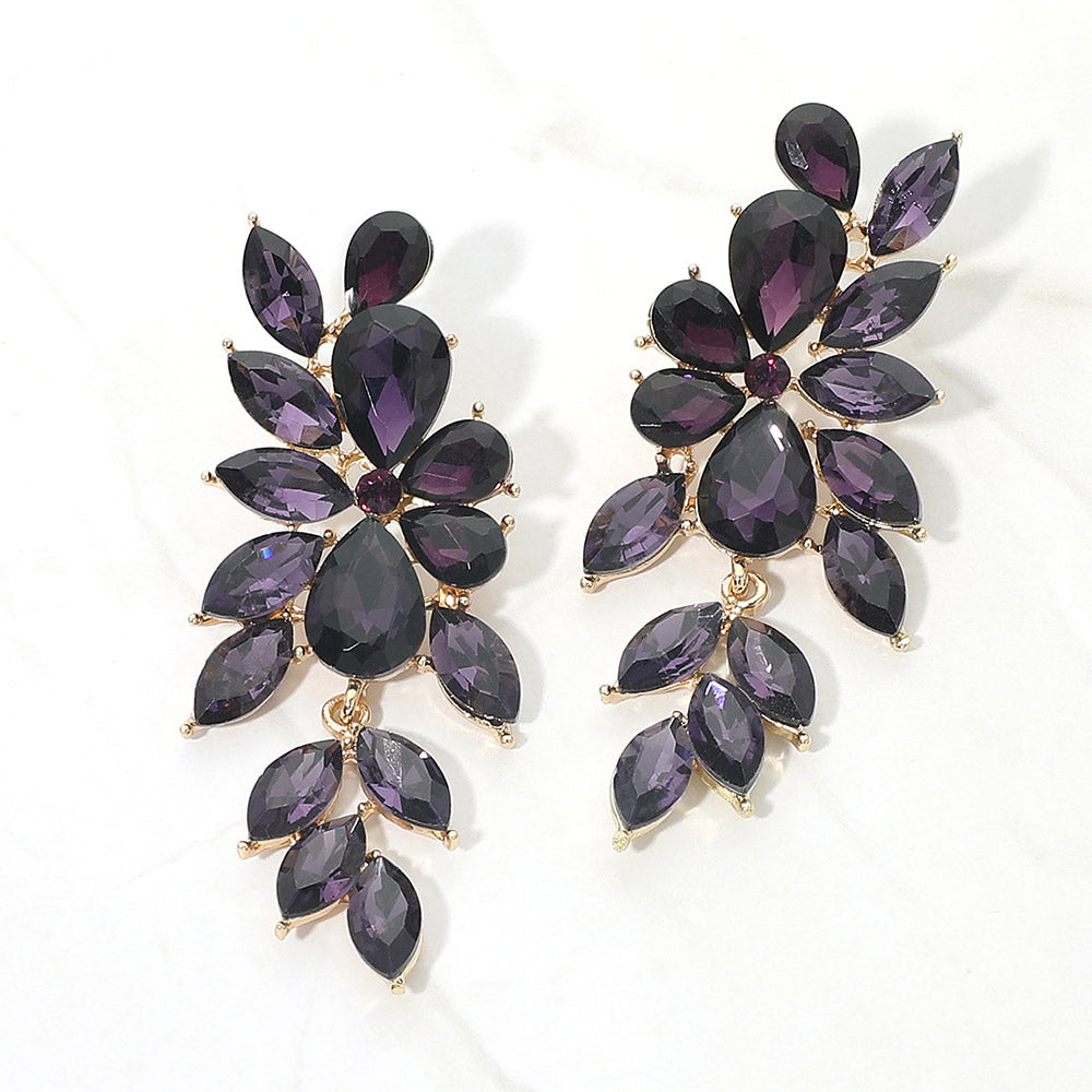 Purple crystal marquise statement earrings on gold with a cascading arrangement of faceted marquise stones, displayed on a white background.