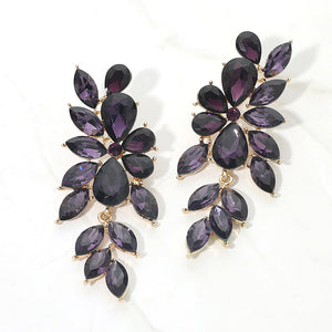 Purple crystal marquise statement earrings on gold with a cascading arrangement of faceted marquise stones, displayed on a white background.
