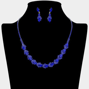 Sapphire Royal Blue marquise crystal necklace set on silver-tone settings, with a slim line of small crystals leading to leaf-shaped marquise stones edged in tiny crystals and matching drop earrings. The necklace measures 16 inches plus a 4-inch extender, with 0.4-inch decor; earrings are 0.9 inches long. Displayed on a black necklace bust against a light gray background.