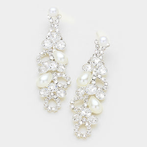 A pair of silver and white pearl fashion earrings with rhinestone embellishments on a white background