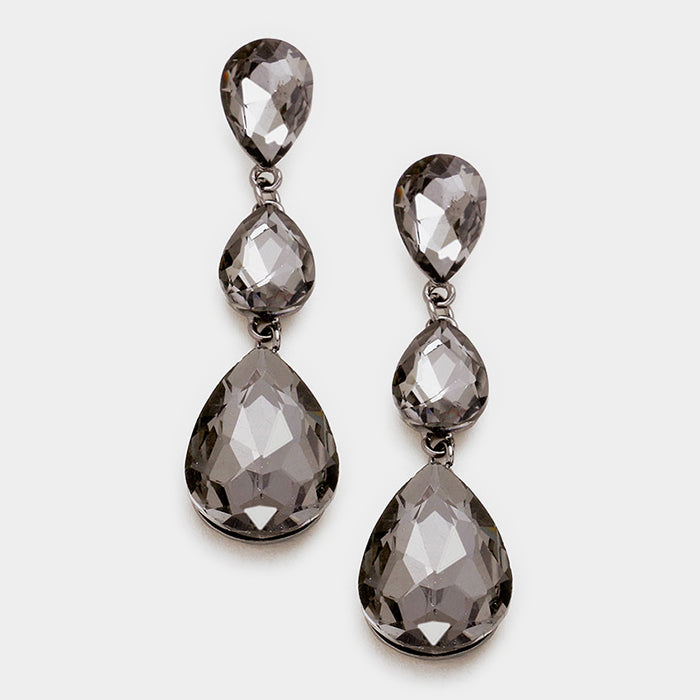 A pair of black diamond teardrop earrings with post back closure on gun metal and a white background