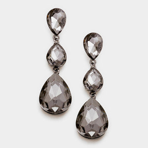 A pair of black diamond teardrop earrings with post back closure on gun metal and a white background